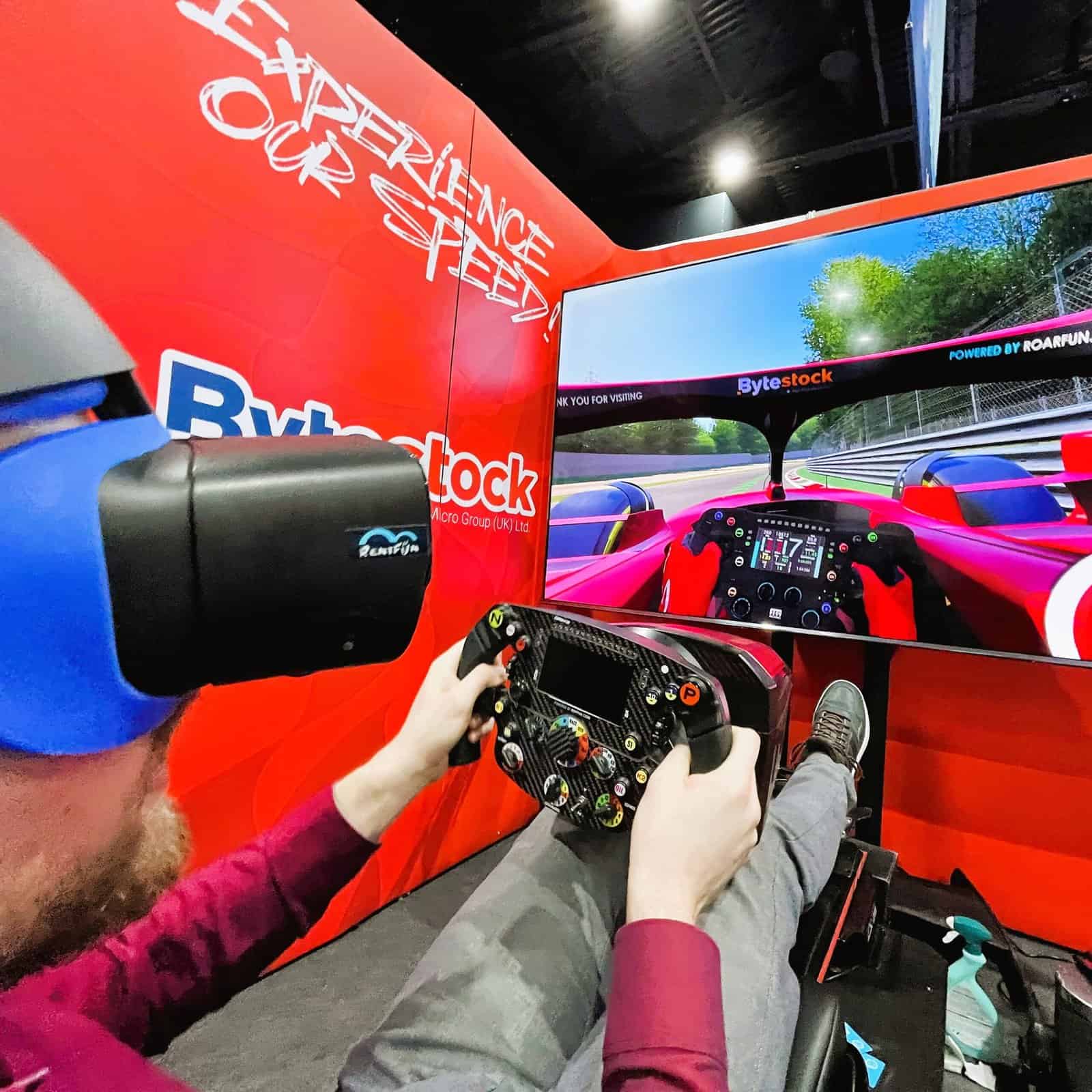 Person driving fast a red formula cr in a Virtual reality at a CloudFest.