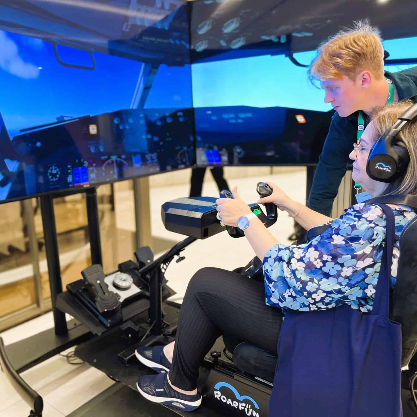 Visitors on a flight simulator.