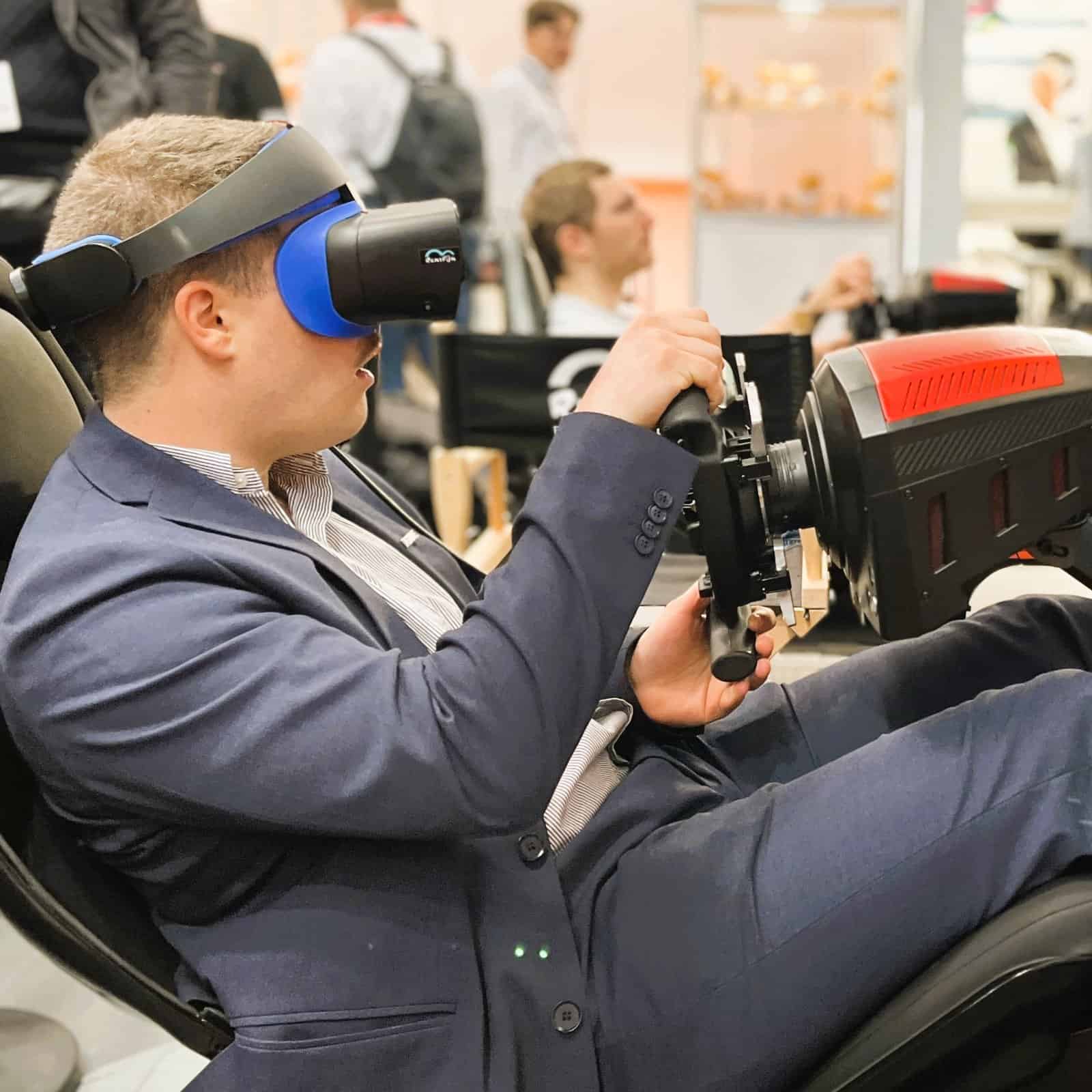 Man in VR on a motion formula simulator hire.