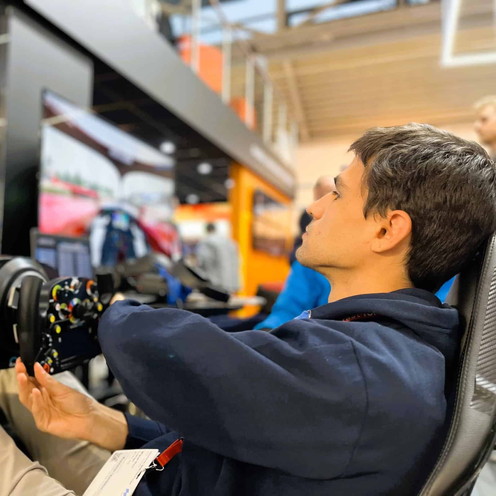 Teenager in EXPO Munich with F1 simulator.